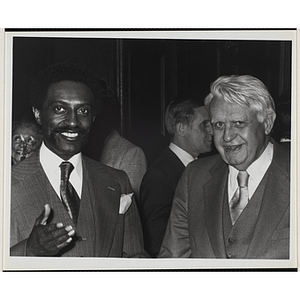 Rev. Michael E. Haynes, on the left, standing with an unidentified man and smiling for the camera at a Boys' Clubs of Boston event