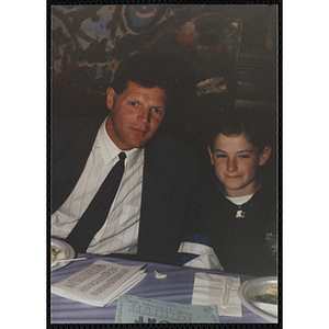 A man and a boy posing for the camera at a Boys & Girls Club Awards Night