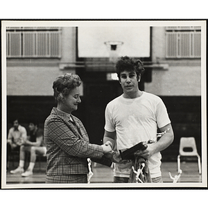 The senior division runner-up receives a trophy in the Boys' Club basketball tournament