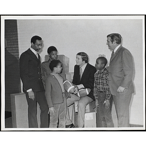 Dick Stockton, former sportscaster for CBS Sports, talks to three Boys' Club members, while Roscoe Baker and Frederick J. Davis look on, at a fund-raising event of the Boys' Clubs of Boston