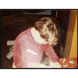 A boy works on an art project at the Boys & Girls Club