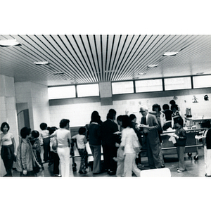 People stand in the cafeteria of the Josiah Quincy School after attending a program for the 29th anniversary celebration of the People's Republic of China