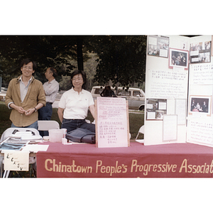 Suzanne Lee and a fellow member of the Chinese Progressive Association stand at the organization's information booth at the Dragon Boat Festival