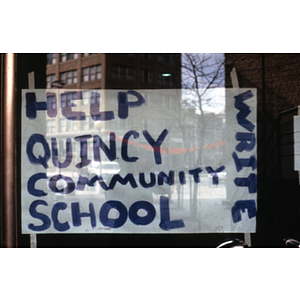 Sign in a window reads, "Help Quincy Community School Write"