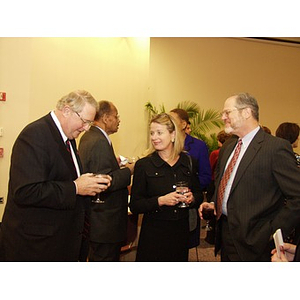 Neal Finnegan (CBA '61), left, conversing with guests at the College of Business Administration's Distinguished Service Awards ceremony