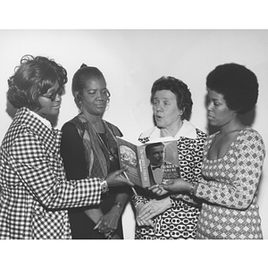 Four women pose together during the book review of Peggy Lawson's "The Glorious Failure" at Northeastern's Afro-American Institute