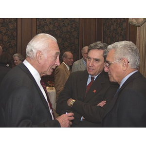 President Richard Freeland, center, and John Hatsopoulos, right, talking to man at gala dinner to honor his contributions to the John Hatsopoulos Scholarship Fund