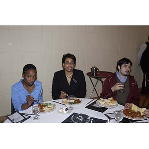 Three students eating at the Student Activities Banquet