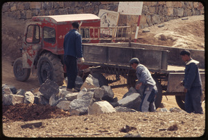 Men loading rocks on truck