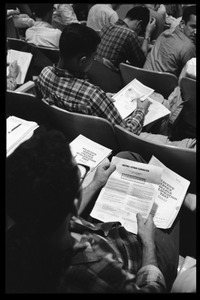 Students looking over the Selective Service College Qualification examination to determine eligibility for an educational deferment from service in the Vietnam War