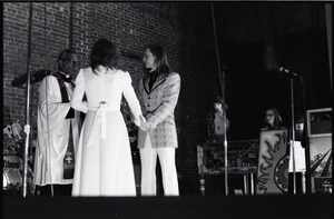 Wedding of Jim and Anne Baker: exchanging vows in front of minister and drum set