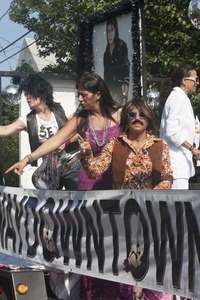 Parade marchers in 1960s attire, in front of a poster of Michael Jackson : Provincetown Carnival parade