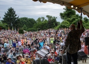 Pete Seeger: view from rear stage, waving goodbye to the audience at the Clearwater Festival