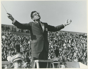 Joseph Contino conducting the marching band at a homecoming game