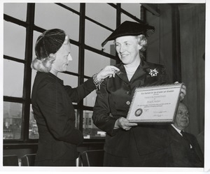 Margaret Milbank Bogert presents Mary Switzer with a pin after receiving the Friend of the Disabled Award at the Institute for the Crippled and Disabled