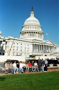 Congressman John W. Olver and group of visitors, posed in front of the United States Capitol building