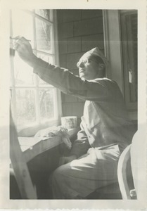 Unidentified man painting window frame