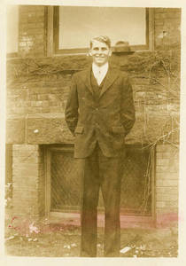 Leon M. Smith standing in front of brick building