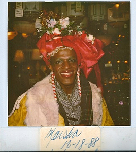 A Photograph of Marsha P. Johnson Wearing a Christmas-Themed Headpiece