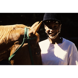 Child standing next to a horse