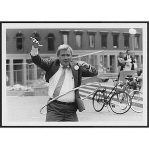 Man in suit using hula hoop