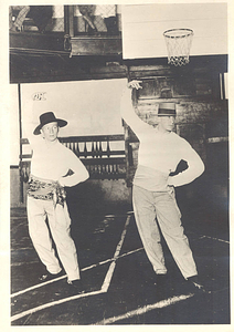 Two dancers on a basketball court