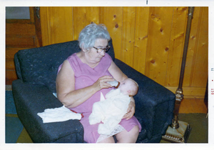 Great grandmother giving 1st great-grandchild a bottle