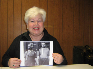 Cate Ryan holding a photograph of her grandfather Joseph Kerans and her great-uncle Edward Kerans