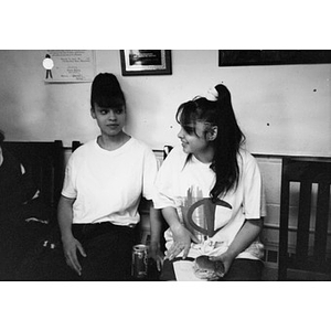 Two unidentified teenage girls sitting inside.