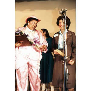 Inquilinos Boricuas en Acción board member receiving flowers during the opening of the Villa Victoria Cultural Center.