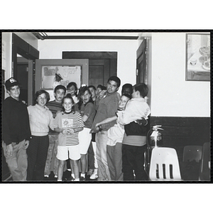 Site coordinators Josh Kraft and Liz Cinquino gather with children for the Tri-Club slide show at the Charlestown Clubhouse