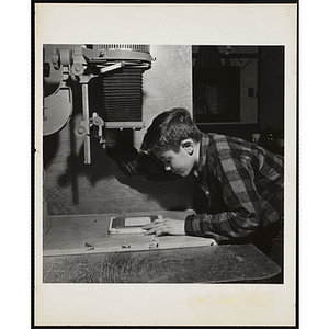 Paul Mahan from the Boys' Clubs of Boston using an enlarger at a photographic laboratory