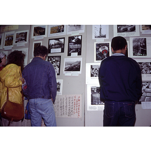 Attendees look at photographs of China on display at an unidentified exhibition