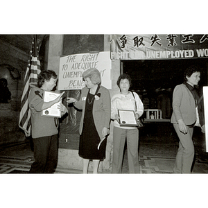 Women presenting awards at an unemployment insurance rally