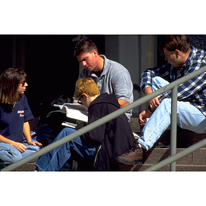 Students studying on the steps of Snell Library