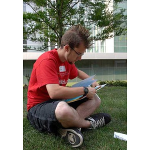 Jordan Munson sits on the grass during a scavenger hunt