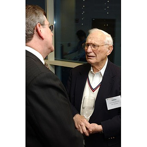 Julius Kendall converses with another man at the 2004 National Council Dinner at Northeastern University