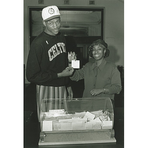 Celtic Reggie Lewis and wife Donna Harris-Lewis hold a winning ticket in the annual Reggie Lewis Turkey giveaway