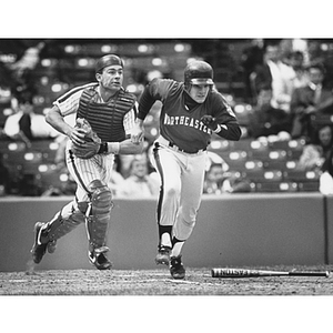 Northeastern baseball player bunts a ball in the first Beanpot baseball tournament at Fenway Park