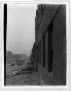 View down the side of the railroad building on Dorchester Ave of construction rubble