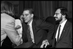 Russell A. Hulse (right) and Joseph H. Taylor (leaning forward) seated at a reception with Massachusetts state legislators honoring their Nobel Prize in Physics