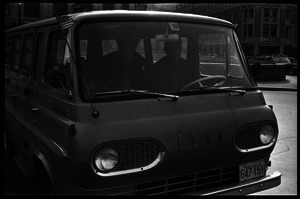 Middle-aged couple in a Ford van (WEZE radio station in background)