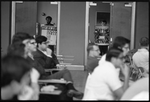 Protesters outside the Selective Service College Qualification examination to determine eligibility for an educational deferment from service in the Vietnam War: 'Taking the test says Let the dummies die.. in Vietnam'