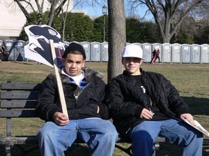 Protesters seated on a bench on the National Mall during the march against the War in Iraq