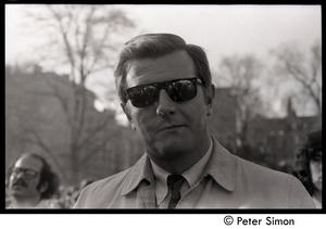 Man in trench coat and sunglasses