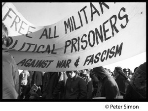 Protesters beneath a banner 'Free all military political prisoners... against war & fascism' (re. Fort Dix antiwar soldiers): Vietnam Moratorium march on Washington