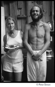 Two attendees standing in the kitchen, eating lunch, Rowe Center spiritual retreat