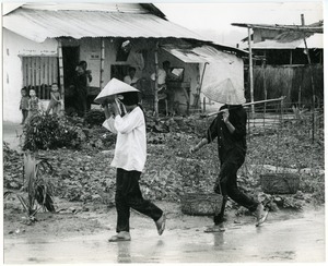 Women on a road during monsoon season