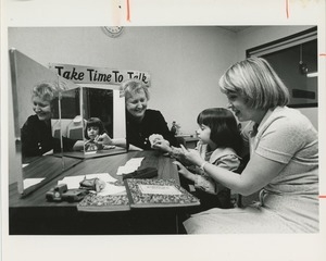 Two speech therapists working with a young girl