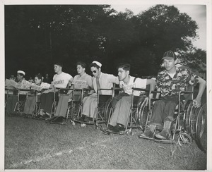 Young men in wheelchairs prepare to race